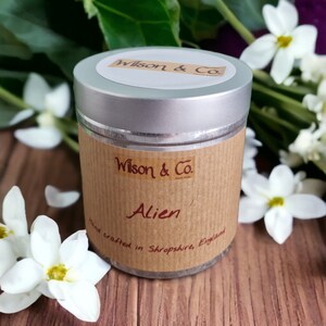 May include: A silver tin candle with a brown label that reads "Wilson & Co. Alien Hand crafted in Shropshire, England".