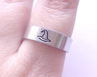 May include: A silver ring with a witch's hat design.