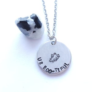 May include: A silver necklace with a round pendant that says "Up Boo-tiful" with a ghost graphic.