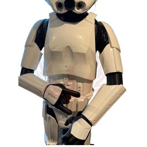 May include: A white Stormtrooper costume with black accents. The costume features a helmet, chest plate, and arm armor. The costume is made of plastic and is designed to look like a Stormtrooper from the Star Wars franchise.
