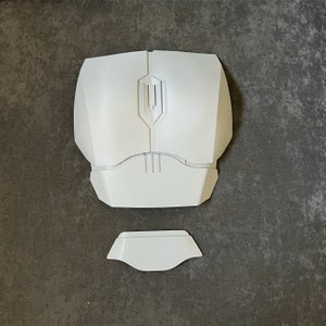 May include: White plastic chest piece with a raised design in the center. The chest piece is for a costume or cosplay.
