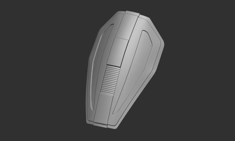 May include: A silver-colored, futuristic-looking shield with a raised, rectangular panel and a series of vertical lines.