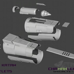 May include: A set of 3D printed parts for a Bo Katan gauntlets prop. The parts are made of gray plastic and are arranged on a gray background. The text "V2 BO KATAN GAUNTLETS" is visible at the bottom of the image.