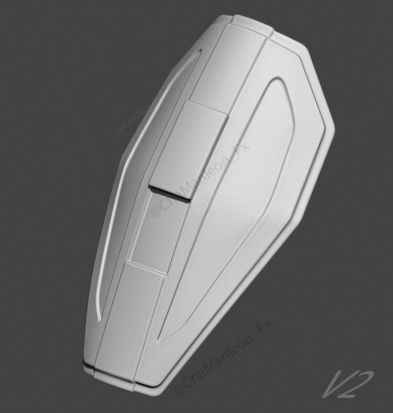 May include: A white 3D printed model of a shield with a textured surface and a raised design. The shield is shaped like a teardrop and has a rounded top. The shield has a raised design on the front, with a rectangular shape in the center and two smaller rectangular shapes on either side. The shield is labeled with the text "@ChaManleon_FX V2".