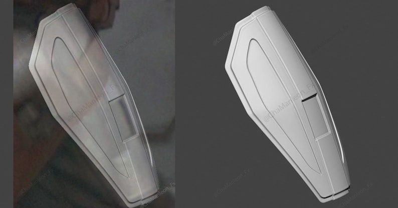 May include: A white, plastic, rectangular shield with a raised, curved design. The shield has a small, rectangular opening in the center.