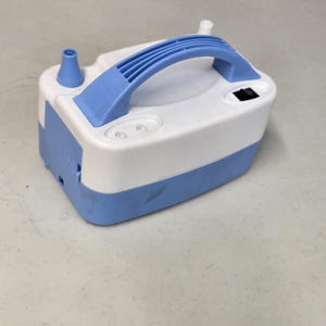 May include: A white and blue electric air pump with a handle. The pump has a power switch and two air nozzles.
