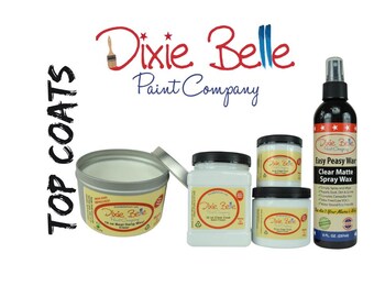 May include: Dixie Belle Paint Company top coats in white jars and a spray bottle. The jars are labeled "Dixie Belle Paint Company" and the spray bottle is labeled "Easy Peasy Wax Clear Matte Spray Wax".