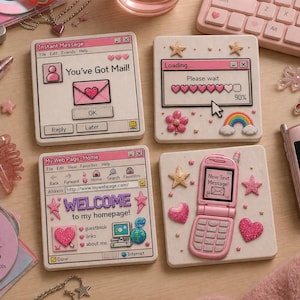 May include: Four square, off-white coasters with pink accents and retro computer-themed designs. One says "You've Got Mail!", another shows a loading bar, a third says "Welcome to my homepage!", and the last has a flip phone.