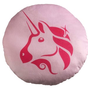 May include: Pink round pillow with a pink unicorn silhouette design.