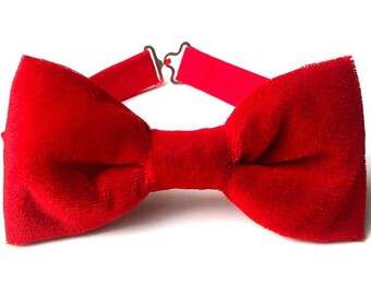 May include: A red velvet bow tie with an adjustable strap.