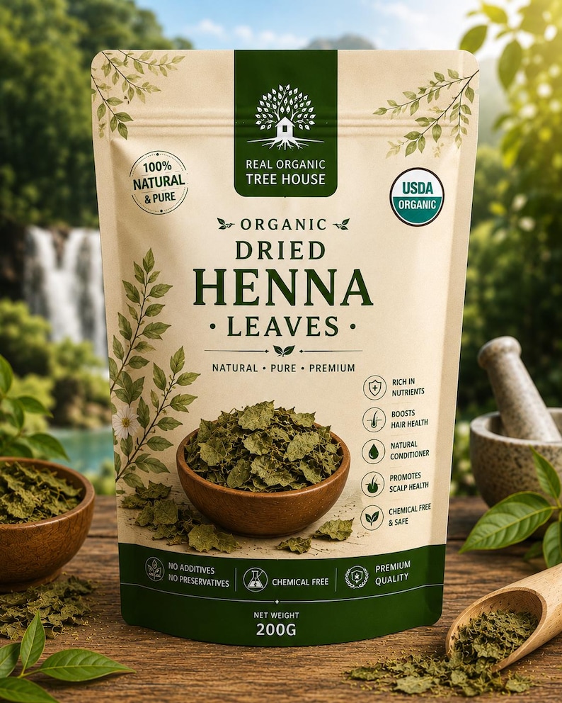 May include: A beige pouch of Real Organic Tree House organic dried henna leaves with a net weight of 200g. The packaging features green text and graphics, including a bowl of dried leaves, a tree logo, and a list of benefits like hair health.
