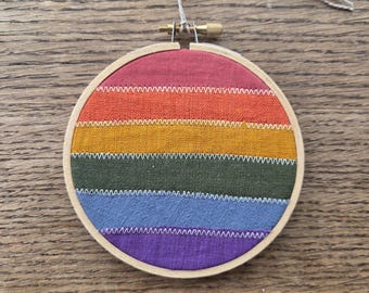 Rainbow patchwork framed in an embroidery hoop