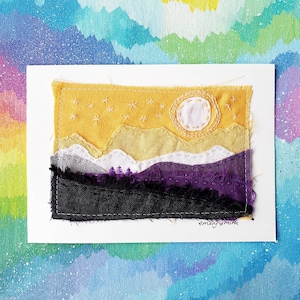 May include: A textile artwork showing a mountain scene with a yellow sky, a white sun, and stars. The mountains are layered in shades of grey, purple, and black. The artist's signature, "emery smith", is in the bottom right corner.