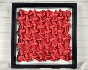Red Half-Expanded Bars framed lattice smocking wall art, geometric fabric manipulation, 3D symmetric origami tessellation, textile art