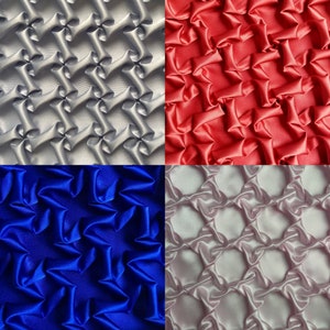 May include: Four fabric swatches showing different quilting patterns. The top left swatch is silver, the top right swatch is red, the bottom left swatch is blue, and the bottom right swatch is pink.