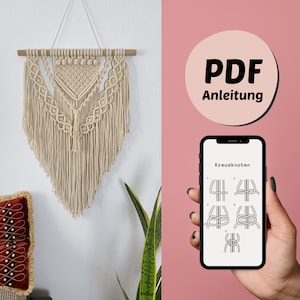 May include: A beige macrame wall hanging with a geometric pattern. A smartphone displays a PDF instruction guide for making a macrame wall hanging, with the text "Kreuzknoten" and diagrams showing how to tie a knot.