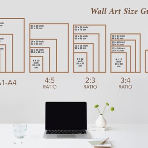 May include: Wall art size guide with dimensions in inches and centimeters. Includes A1-A4 sizes, and 4:5, 2:3, and 3:4 ratio sizes. A laptop, a glass of water, and a vase with flowers are on a white desk.