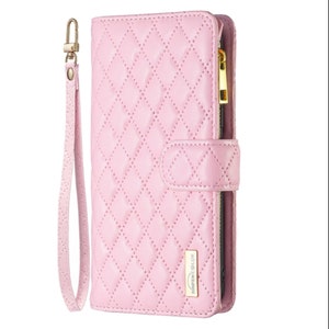 May include: A light pink quilted wallet with a wrist strap and gold-colored zipper. The wallet has a diamond pattern and a snap closure. The brand name "BINFEN COLOR" is visible on the bottom right corner.