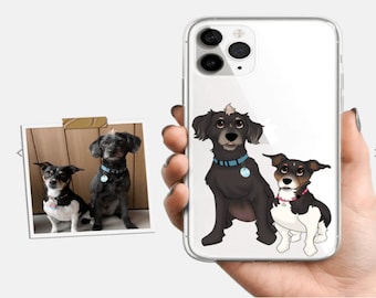 Op de afbeelding: Transparante telefoonhoes met een aangepaste illustratie van twee honden. De honden zijn zwart, wit en bruin, met blauwe en roze halsbanden. Een ingelijste foto van de honden is ook zichtbaar.