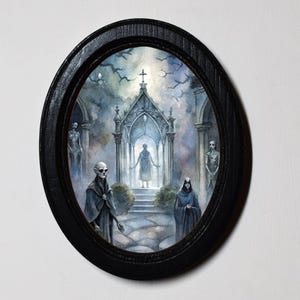 May include: Oval framed watercolour painting depicting a gothic scene. Figures in dark cloaks stand before a chapel with a cross. The artwork features a muted colour palette of blues, greys, and whites, creating a mysterious and atmospheric aesthetic.