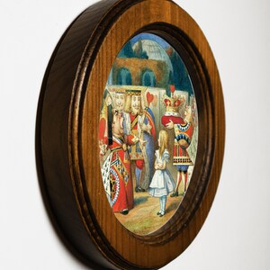 May include: A framed illustration of a scene from Alice in Wonderland. The Queen of Hearts is yelling at Alice, while the King of Hearts and other characters look on.