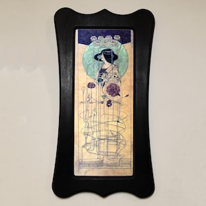 May include: A framed print of an Art Nouveau style illustration featuring a woman in a black hat and dress standing in a garden with flowers and vines. The print is in a black frame with a decorative border.