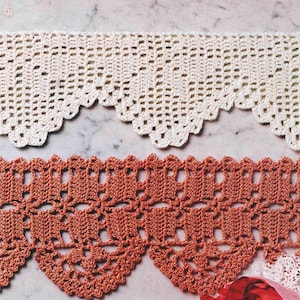 May include: Two crochet lace trims are shown. The top trim is cream-coloured with a scalloped edge. The bottom trim is a terracotta colour, also with a scalloped edge. The lace has an open design, suitable for craft projects.