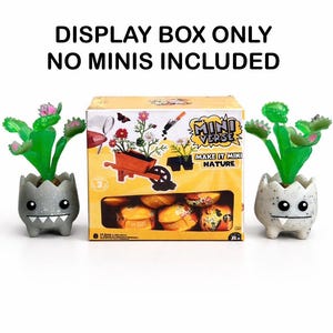 May include: A display box with the text "DISPLAY BOX ONLY NO MINIS INCLUDED". The box features a "MINI VERSE" theme with miniature plants and a wheelbarrow. Two small, gray, egg-shaped planters with green plants flank the box.