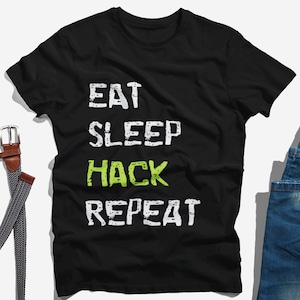 May include: Black t-shirt with white text that reads "Eat Sleep Hack Repeat" with the word "Hack" in green.
