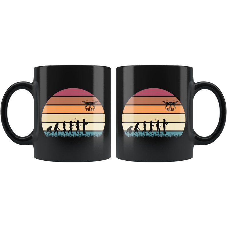 May include: Two black coffee mugs featuring a retro sunset design with a silhouette of a person holding a drone. The text "Drone Pilot" is printed on the mug.