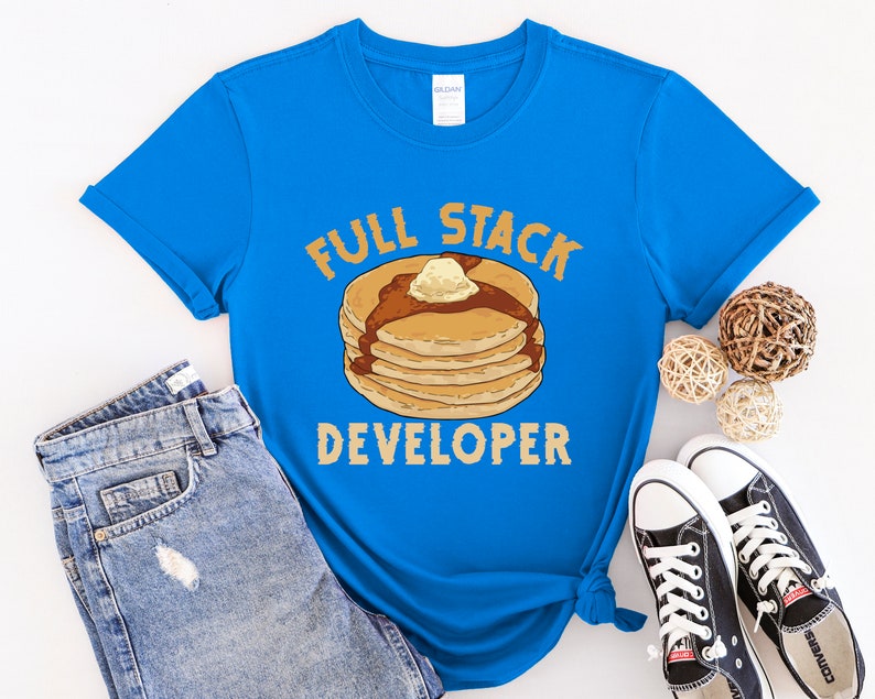 K&ouml;nnte beinhalten: Ein blaues T-Shirt mit einer Grafik eines Stapels Pfannkuchen und dem Text "Full Stack Developer".