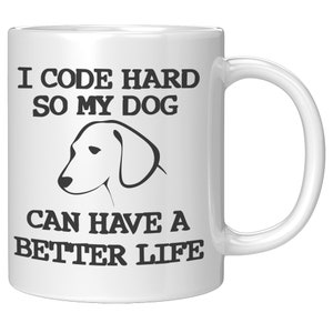 May include: White ceramic coffee mug with black text that reads "I code hard so my dog can have a better life". A black and white illustration of a dog's head is centered above the text.