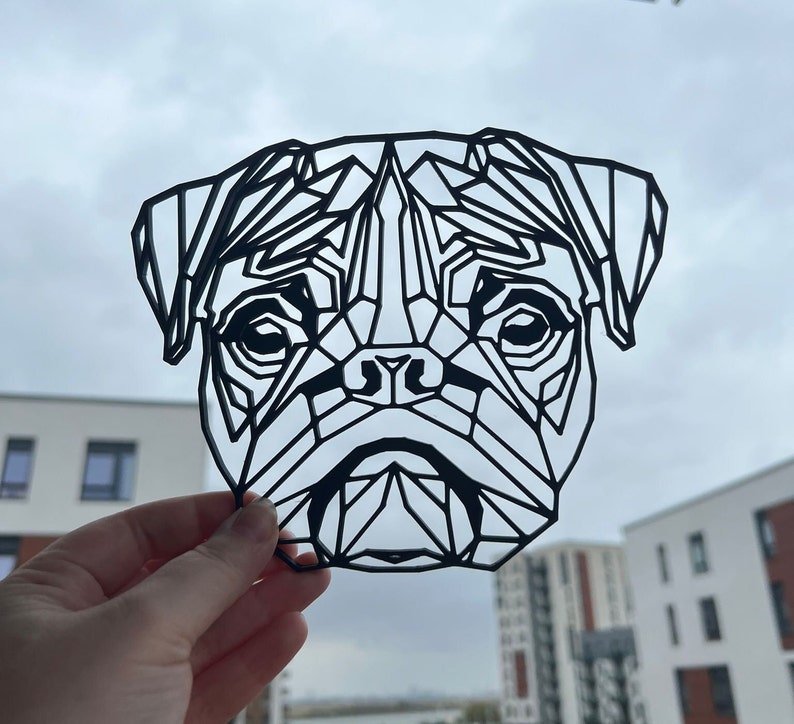 May include: Black and white geometric design of a pug dog's face. The design is made of many triangles and lines, creating a modern and abstract look.