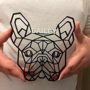 May include: A black geometric design of a French Bulldog head with the name "BAILEY" written in white letters above the dog's head.