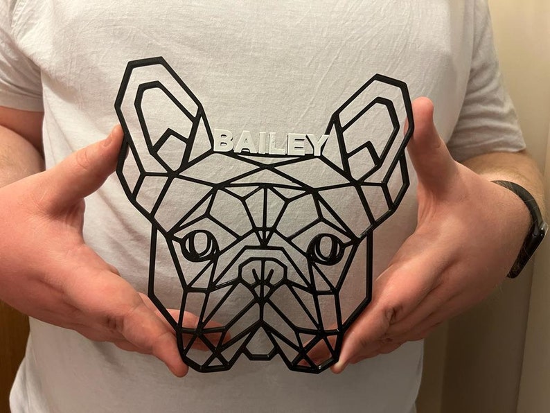 May include: A black geometric design of a French Bulldog head with the name "BAILEY" written in white letters above the dog's head.