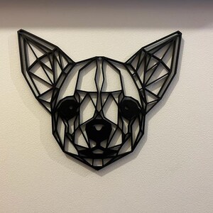 May include: Black geometric wall art of a chihuahua's head. The art is made of thin metal and is in a low-poly style.