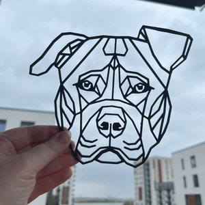 May include: Black and white geometric design of a dog's head, resembling a pit bull terrier.