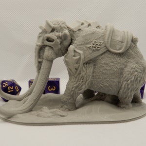 May include: A gray 3D printed miniature of a mammoth with a saddle and tusks. The mammoth is standing on a gray base. There are three purple dice with gold numbers on the base.