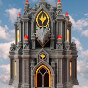 May include: A gray, multi-tiered castle structure featuring a central dragon head relief, gold-colored accents, and a pointed arch doorway. The building is topped with small red finials and includes a gold-colored emblem above the entrance.