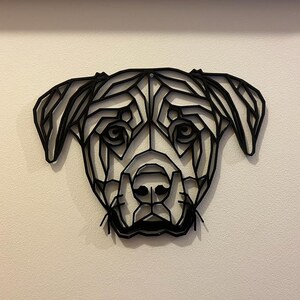 May include: Black and white geometric design of a dog's head. The design is made of many triangles and lines, creating a modern and abstract look.