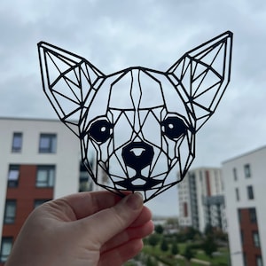 May include: Black geometric paper cutout of a chihuahua's head.