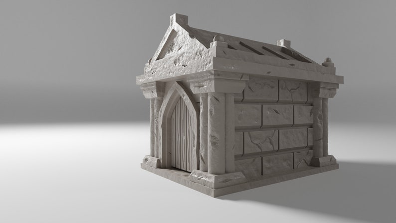 May include: A small, grey stone mausoleum with a single arched doorway and a decorative roof. The mausoleum is made of rough-hewn stone and has a weathered appearance.