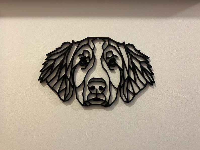 May include: Black and white geometric silhouette of a dog's head, with a detailed design of the fur and facial features.