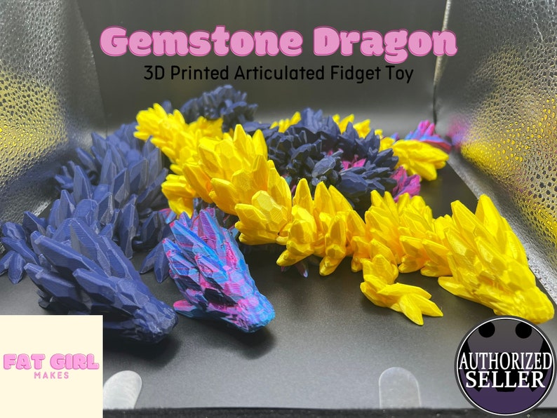 May include: A 3D printed articulated fidget toy in the shape of a dragon. The dragon is made of blue, yellow, and pink plastic and has a gemstone-like texture. The toy is called "Gemstone Dragon" and is a 3D printed articulated fidget toy.