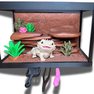 Puede incluir: Una taza de cerámica blanca con un asa negra y el texto "But First, Coffee" en negrita negra. La taza se encuentra sobre un fondo borroso, resaltando su diseño limpio.