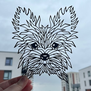 May include: Black paper cut-out of a Yorkshire Terrier dog with a geometric design. The dog's fur is made up of many small triangles and squares.
