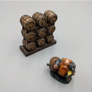 May include: A miniature wooden barrel rack with 10 barrels stacked in a wall formation. A miniature dwarf figure is sitting on a barrel with a mug in hand.