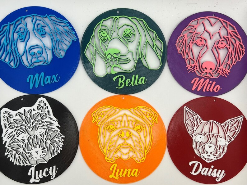 May include: Six round, colorful ornaments with geometric animal illustrations and names. The ornaments are blue, green, purple, black, orange, and red. The animals are a dog, a wolf, a bulldog, and a chihuahua. The names are Max, Bella, Milo, Lucy, Luna, and Daisy.