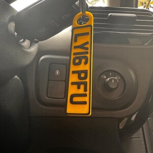 May include: A yellow keychain with the word "LY16PFU" printed in black letters.