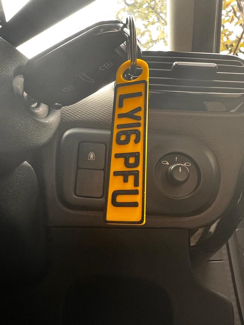 May include: A yellow keychain with the word "LY16PFU" printed in black letters.